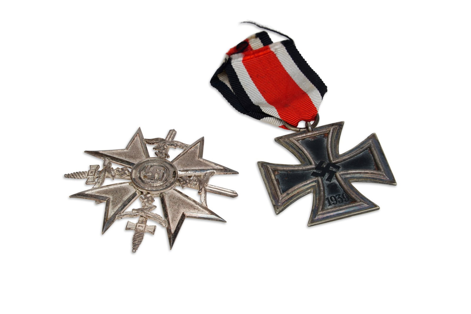 A GERMAN 1939 IRON CROSS SECOND CLASS AND A GERMAN SPANISH CROSS: the iron cross stamped 24 to the suspension ring, for manufacturer Arbeitsgemainschaft der Hanaeur Plakettenherteller; the Spanish Cross with swords. (2)