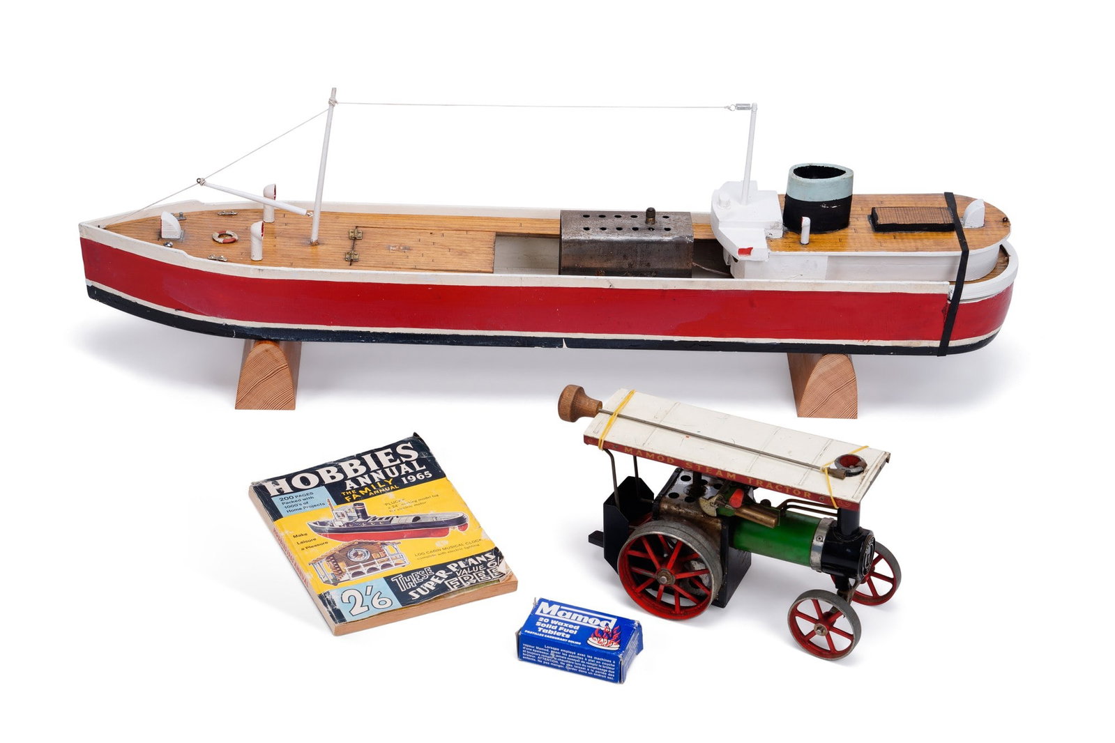 A MAMOD STEAM ENGINE POWERED 'SS ACTIVITY' MODEL BOAT: together with a Hobbies Annual 1965 book, the boat listed on page 138; and a Mamod live steam model traction engine, TE1A, with burner, steering rod and fuel. (3)