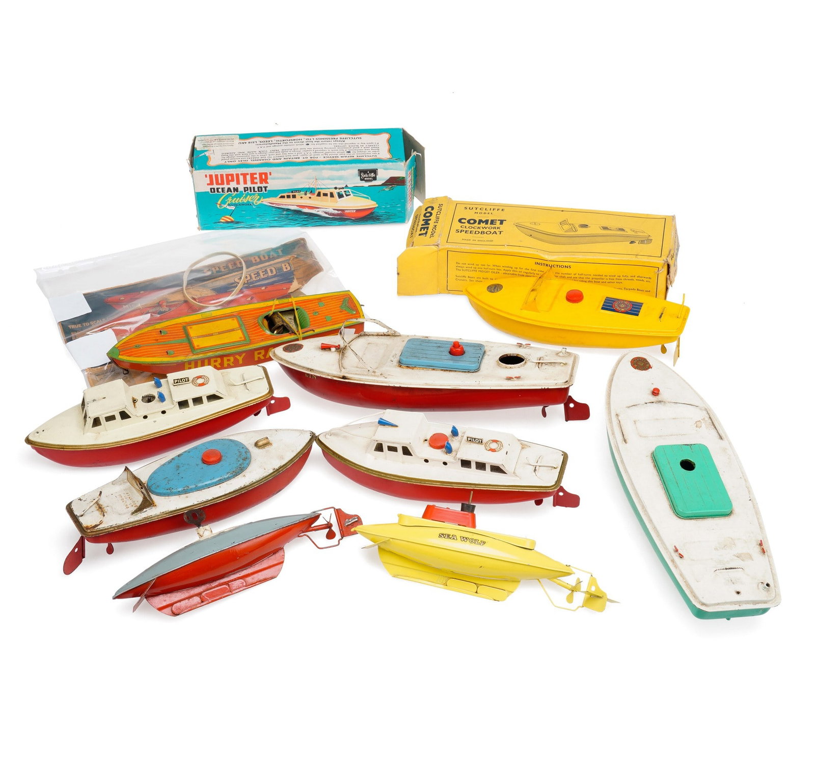 A GROUP OF MODEL BOATS AND SUBMARINES: comprising a Sutcliffe 'Jupiter' Ocean Pilot clockwork cruiser, with box; a Sutcliffe 'Comet' clockwork speedboat, with box; a tinplate 'Hurry Racer' speedboat, from the HappyNak series, Made in
