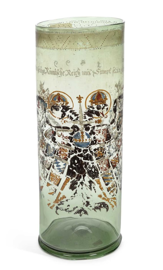 A BOHEMIAN OR FRANCONIAN ENAMELLED REICHSADLERHUMPEN, DATED 1599: of tall cylindrical form and of green tint, painted in black with the crowned Imperial double-headed eagle, an orb on its breast, its wings supporting the shields of the provinces of the Holy Roman Em