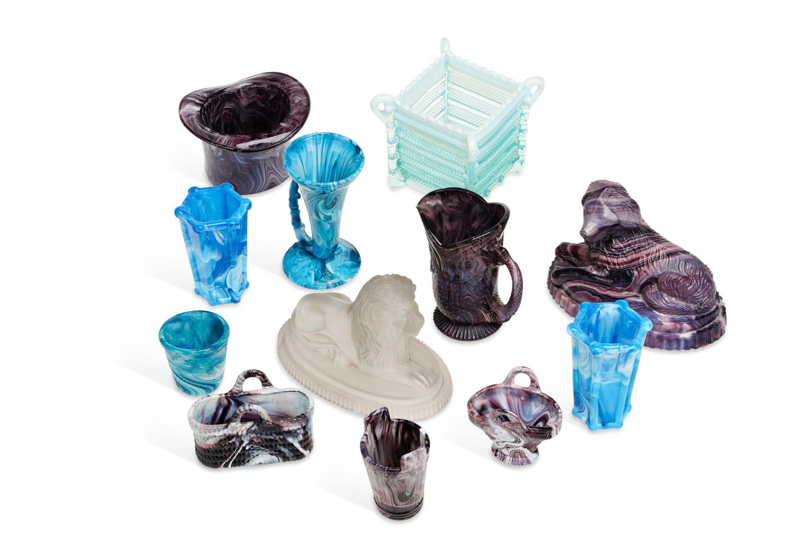 A COLLECTION OF VICTORIAN PRESSED GLASS: comprising eleven pieces of North East malachite glass including a purple model of a recumbent dog, a pair of blue panelled vases, a trumpet vase with a scrolling handle, a jug, a top hat spill vase, 