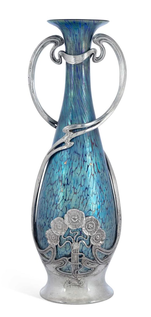 A LOETZ IRIDESCENT GLASS VASE IN AN ART NOUVEAU PEWTER MOUNT CIRCA 1900: of tapering ovoid form with a flared trumpet neck, the glass in blue and green iridescence over a dark veined ground, the Juventa pewter mount cast with twin scrolling loop handles and a band of styli