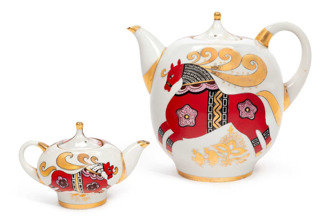 TWO LOMONOSOV PORCELAIN TEAPOTS CIRCA 1960: with stylised decoration of horses, cockerels and floral motif, printed marks to the bases. (2) Largest 22cm high