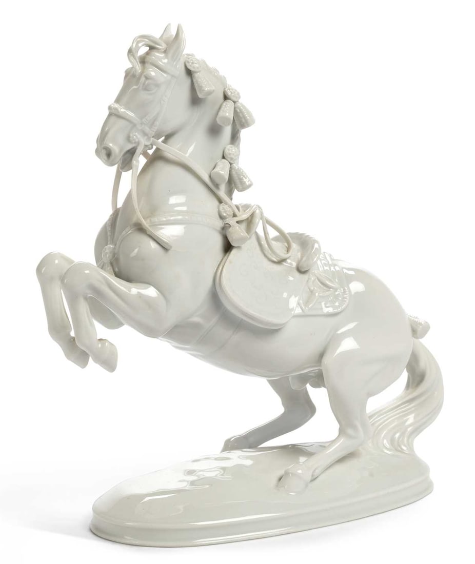 A VIENNA PORCELAIN FIGURE OF A HORSE 20TH CENTURY: modelled in the white, as Levade from the Spanish Riding School Series, painted and impressed marks. 22cm high
