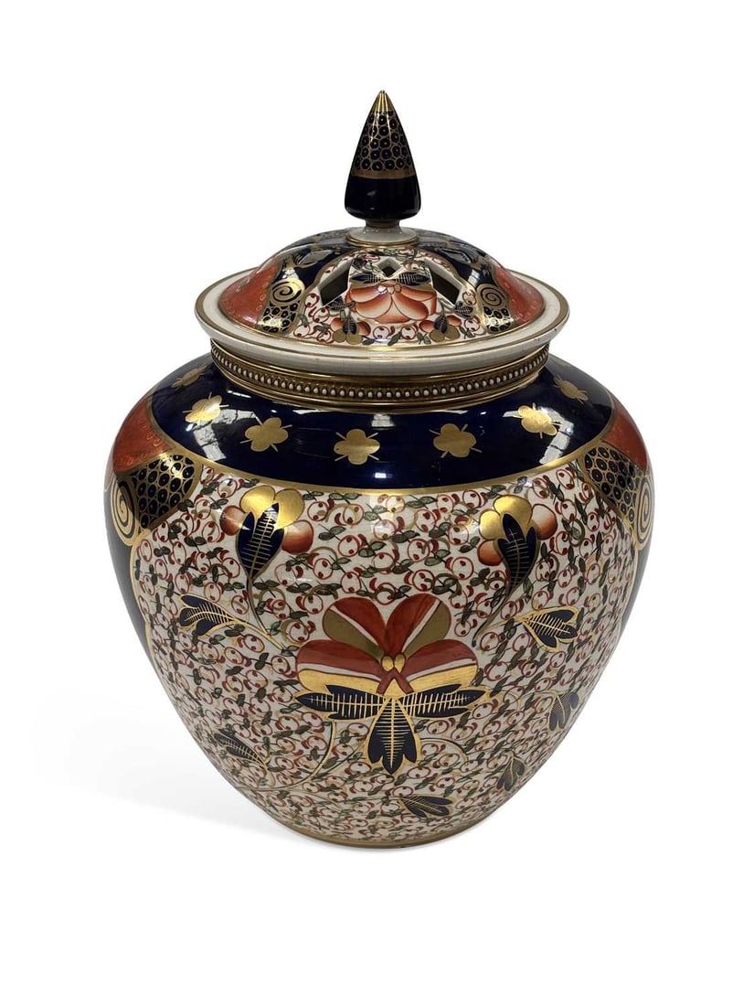 A DAVENPORT PORCELAIN POT POURRI VASE, COVER AND LINER CIRCA 1870: of globular form, the pierced domed cover with a spire finial above a beaded gilt collar, painted in the Imari palette with stylised flowering plants in iron-red, cobalt blue, green and gilt, the