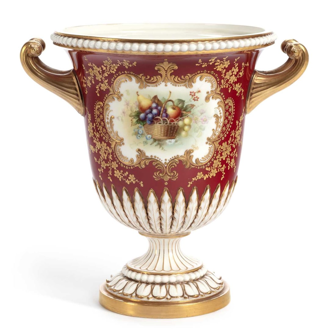 A ROYAL WORCESTER PORCELAIN URN DATED 1902: finely painted with a basket of fruit, in a gilt scroll panel on a claret ground, signed Hawkins for William Hawkins, puce printed factory marks and date code for 1902. 21.5cm high