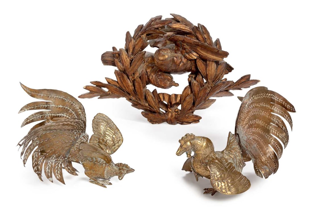 A 19TH CENTURY CARVED GILTWOOD PLAQUE AND TWO BRASS COCKERELS: the first carved as two birds emerging from between a laurel wreath, tied with a ribbon at the base; together with two brass cockerels. (3) First 48cm wide by 28cm high