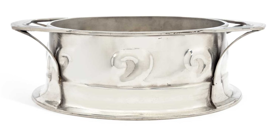 OLIVER BAKER FOR LIBERTY & CO A LARGE TUDRIC PEWTER TWO-HANDLED JARDINIERE: no. 0191, oval, the body with swirl decoration to the sides, on a spreading oval foot, stamped marks. 32.5cm over handles