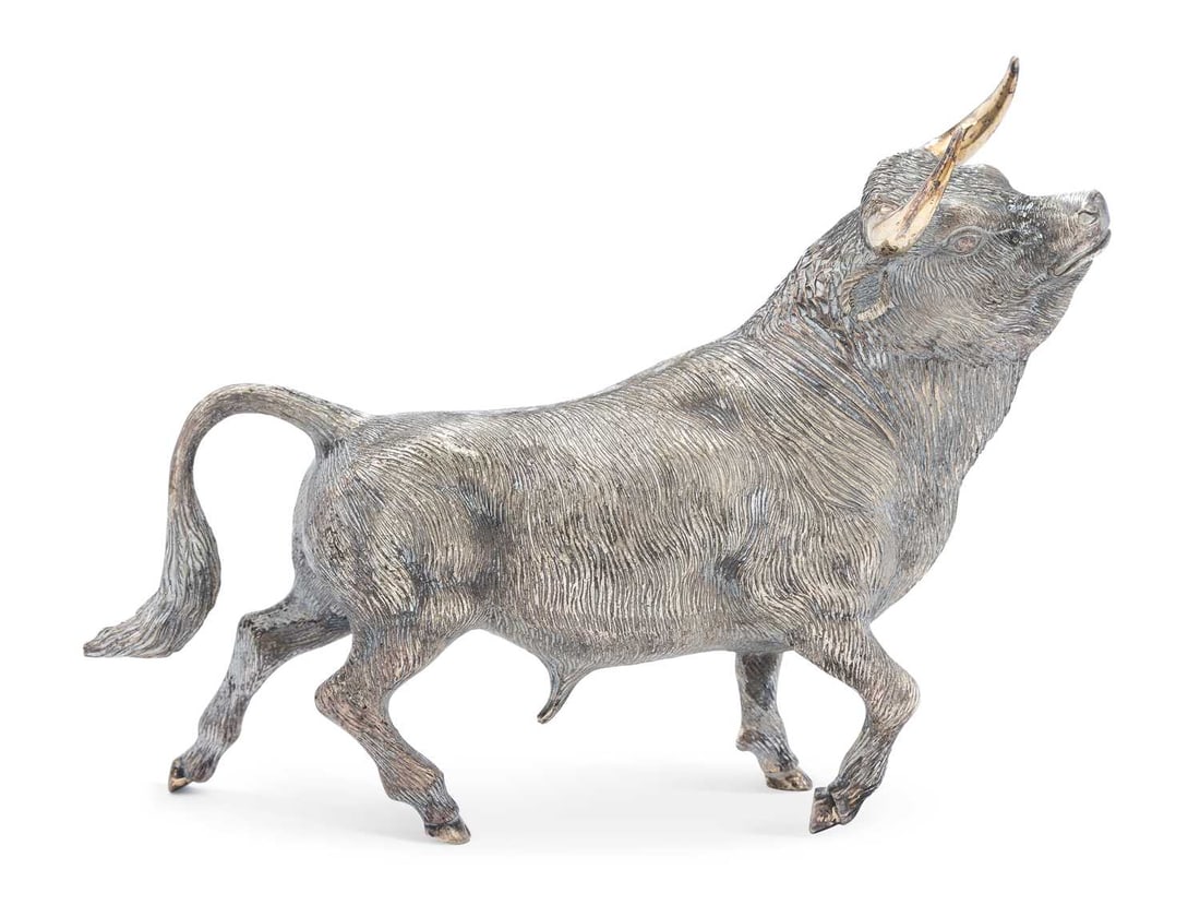 A SILVER-PLATED MODEL OF A BULL: realistically cast trotting with a raised head, marked ALPACA to the body. 20cm long