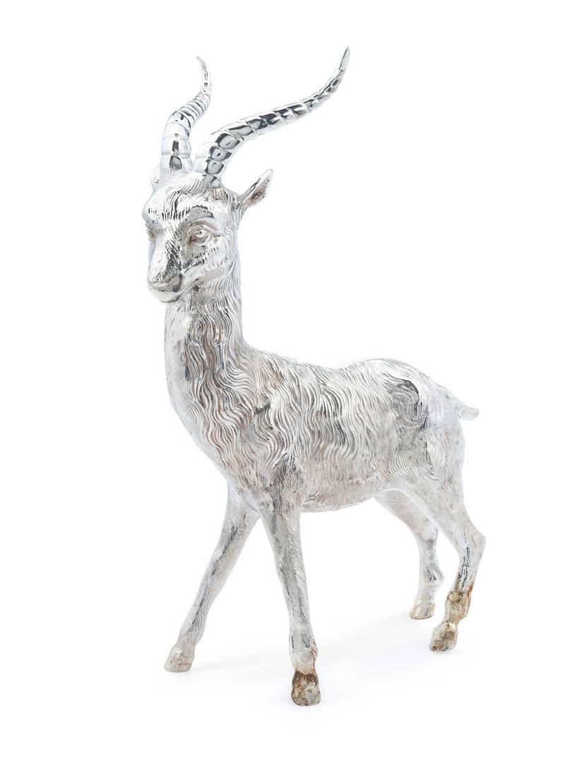 A LARGE SILVER-PLATED MODEL OF AN ANTELOPE OR IMPALA: realistically modelled standing. 28cm high