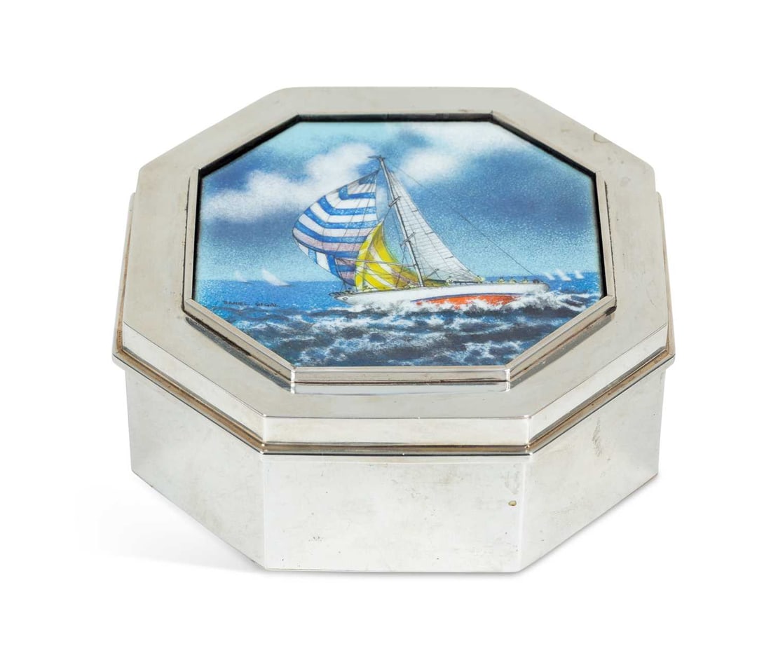 AN AMERICAN STERLING SILVER AND ENAMEL BOX CIRCA 1960S: by Wolfgang Schroth, octagonal, the cover enamelled with a yacht in a seascape with striped spinnaker, signed Daniel Sigal, the box with facsimile Schroth signature to base and stamped HAND MADE