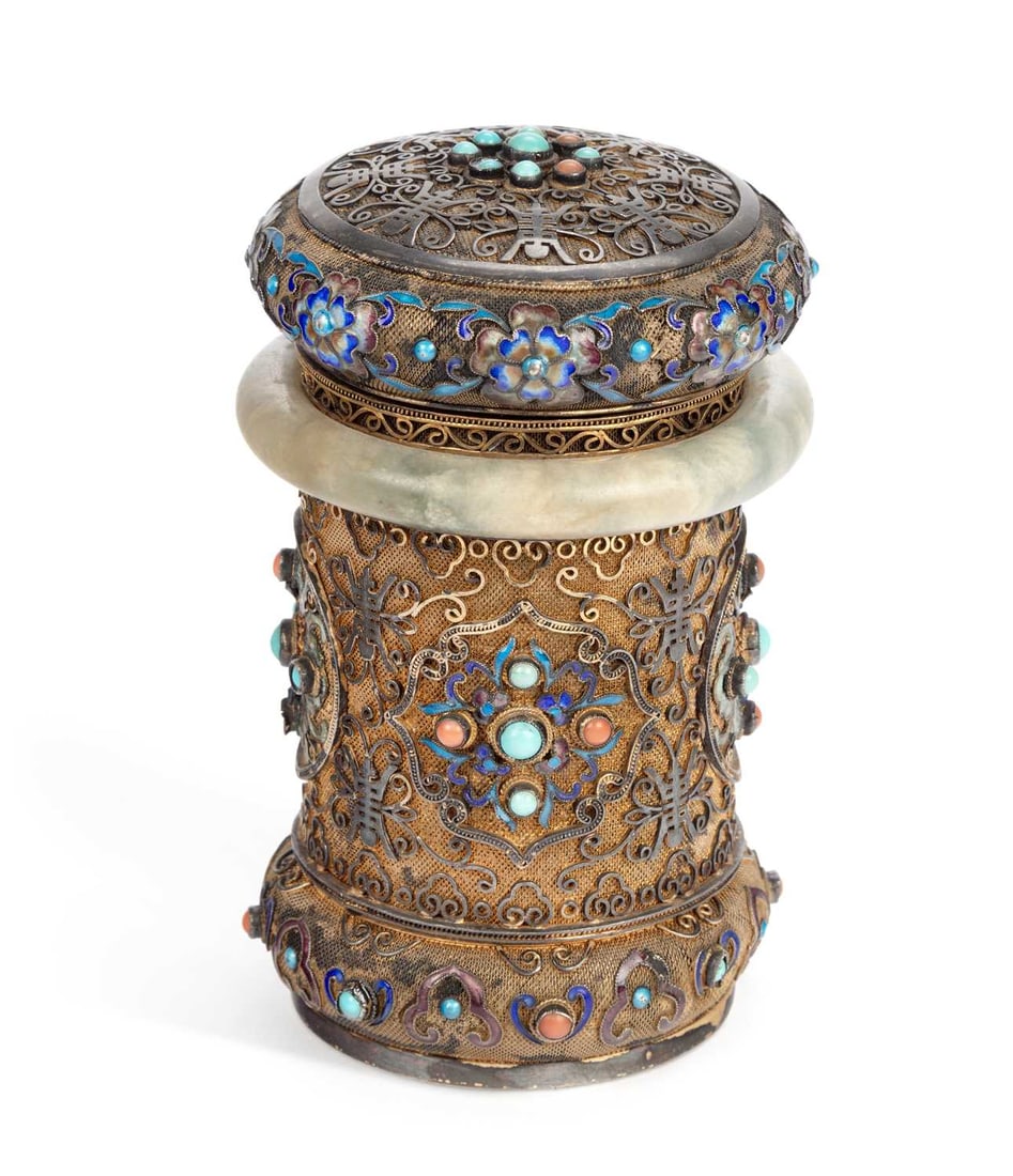 A CHINESE SILVER FILIGREE, ENAMEL AND JADE BOX AND COVER: stamped SILVER, of waisted cylindrical form, the filigree ground applied with shou characters and scrolling tendrils, decorated with polychrome enamel florets and set with turquoise and coral