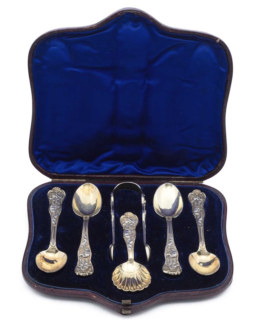 A CONTINENTAL CASED SET OF SILVER AND SILVER-GILT TEASPOONS, CADDY SPOON AND SUGAR TONGS LATE 19TH/: possibly French, each with handles finely cast with stag hunting scenes, spoons with scallop shell terminals, backs cast with a quiver of arrows and masks, within fitted velvet and silk lined case. Te