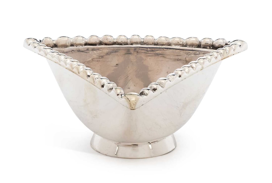 A GEORGE V SCOTTISH SILVER 'TRAPRAIN TREASURE' REPRODUCTION DISH: by Brook & Son, Edinburgh 1930, of triangular form with beaded border, raised on a pedestal foot, stamped to base Traprain Treasure 11919 Authorised Reproduction. 10.5cm by 11.5cm by 5cm, 5 troy ounce