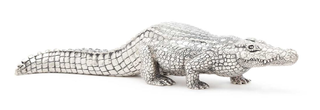 PATRICK MAVROS: A LARGE SILVER MODEL OF A CROCODILE: Zimbabwe hallmarks and maker's mark, realistically modelled in standing pose with curved tail, dated 07.09.05. 22cm long, 18.1 troy ounces