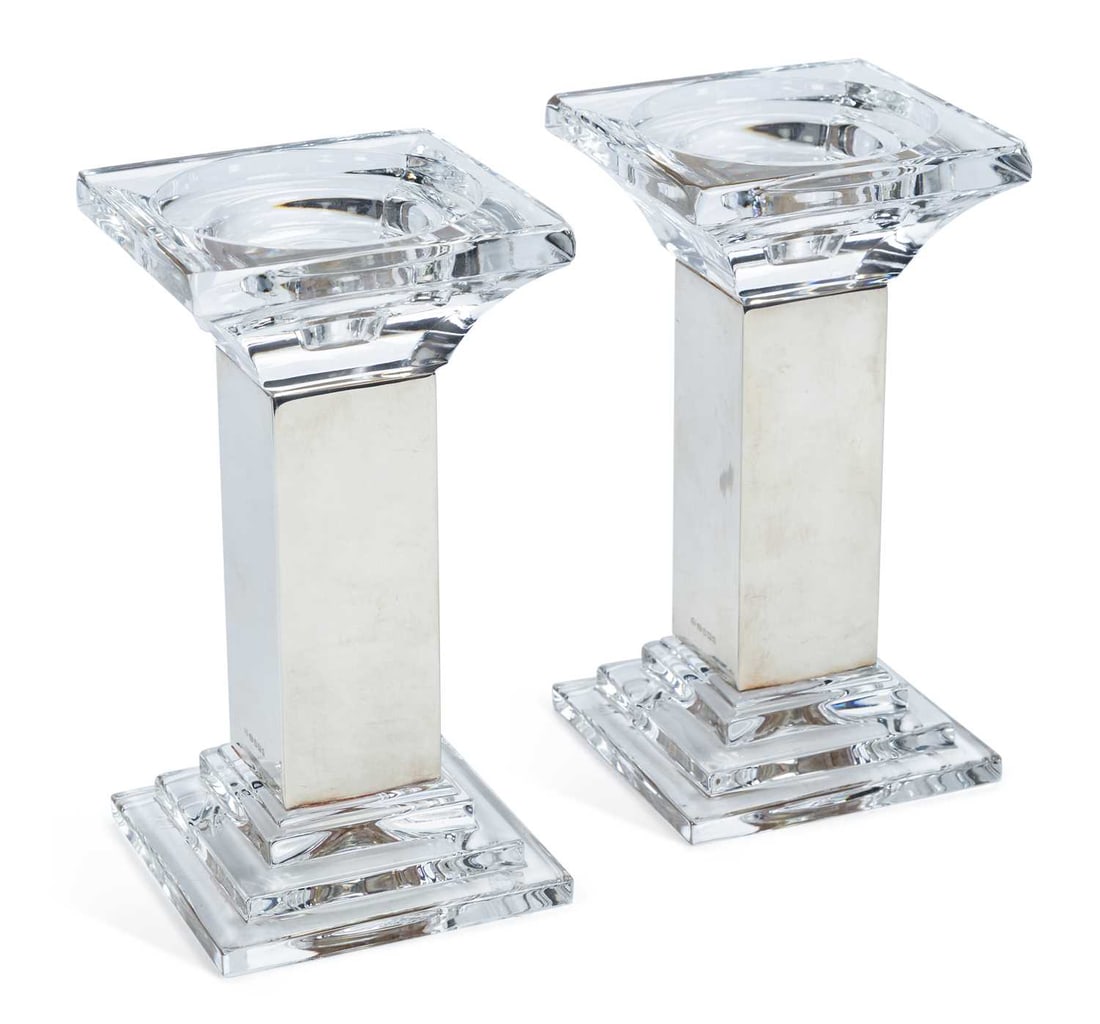 A PAIR OF ELIZABETH II SILVER-MOUNTED CUT GLASS CANDLESTICKS: by Mappin & Webb, Sheffield 2007, of square column form, with silver mounted stem, swept sconce and stepped foot. (2) 17.8cm high Good condition overall, dings in places to silver.