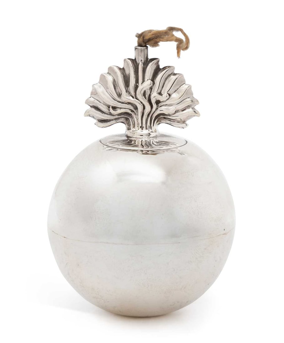A GEORGE V SILVER NOVELTY TABLE LIGHTER: by Turner & Simpson Ltd., London 1931, in the form of a flaming grenade, with screw-off flame finial. 8.5cm high Good condition, with light wear and tarnish. Complete with rope wick.