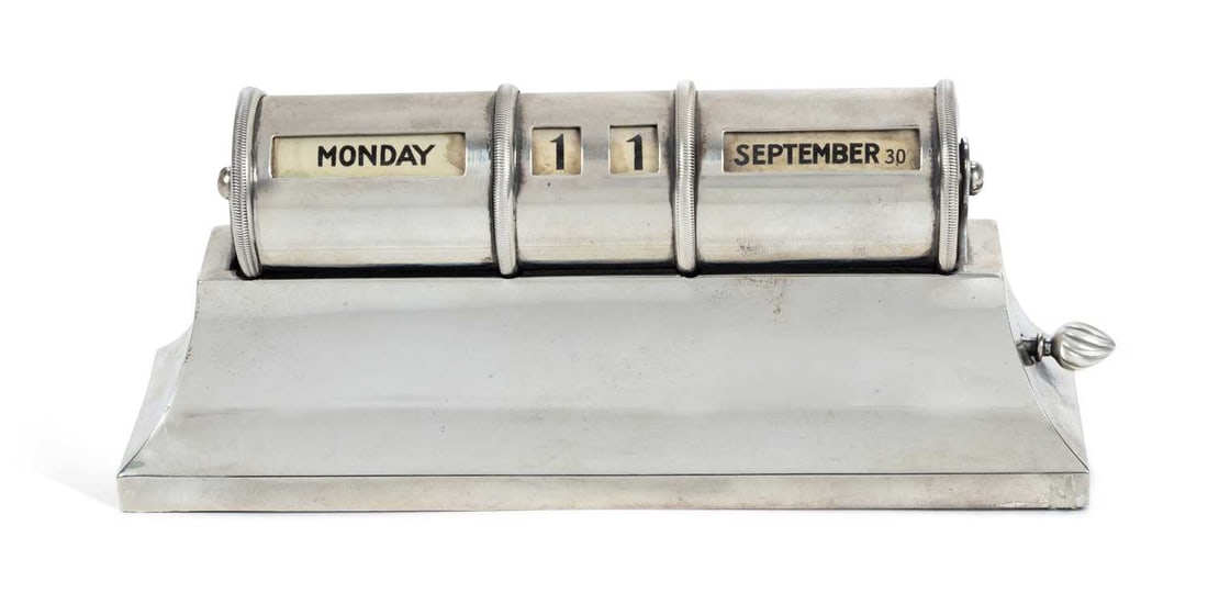 A GEORGE V SILVER DESK CALENDAR: by Padgett & Braham Ltd, London 1927, the drum calendar set upon a sweeping rectangular pedestal base, SUBSCRIBERS TO PRESENTATION TO EVELINE E. M. BUTT JAN. 31ST 1928 on a pull-out scroll to the reve