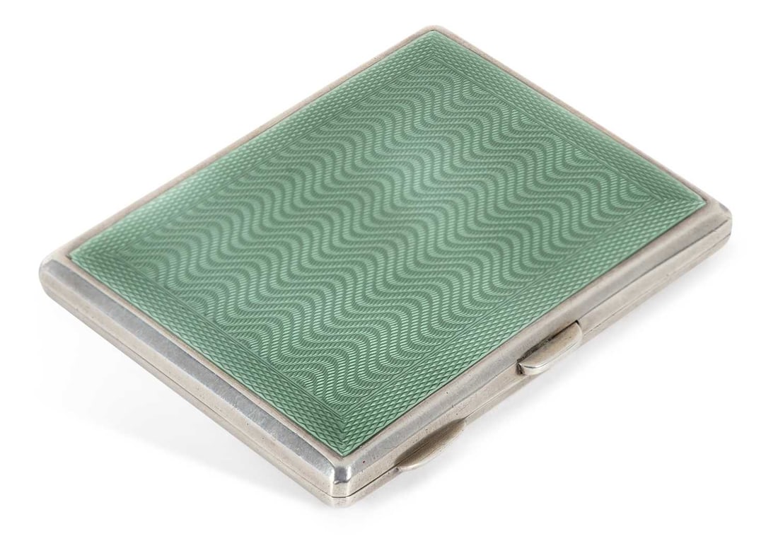 A GEORGE V ART DECO SILVER AND ENAMEL CIGARETTE CASE: by Deykins & Harrison, Birmingham 1932, of rectangular form, hinged, decorated to front and rear covers with jade green enamel, gilt washed interior. 8.2cm wide, 4 troy ounces gross