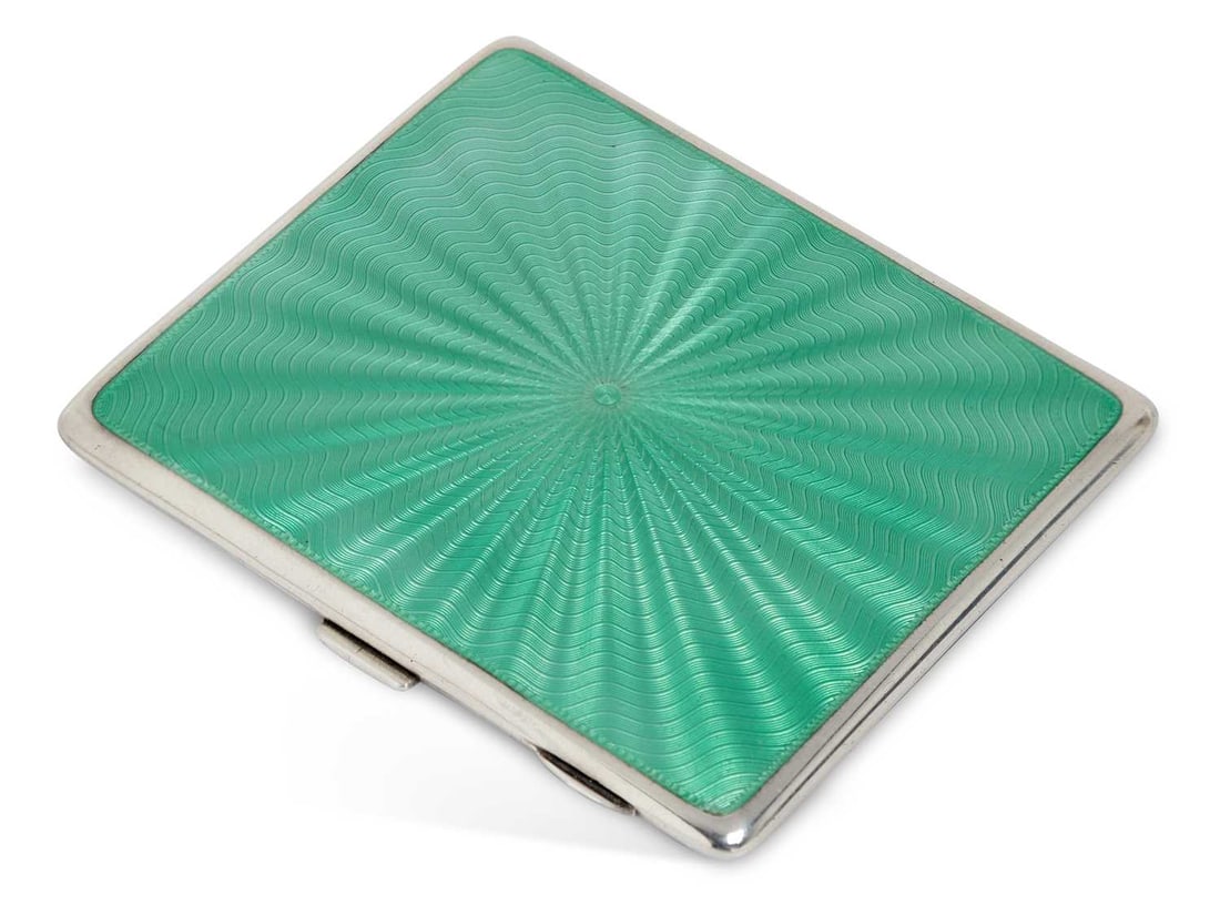 A GEORGE V SILVER AND ENAMEL CIGARETTE CASE: by William Neale Ltd., Birmingham 1933, of rectangular form, decorated to front and rear covers with jade green enamel, gilt wash interior. 9.7cm wide, 4.8 troy ounces gross Good condition overall