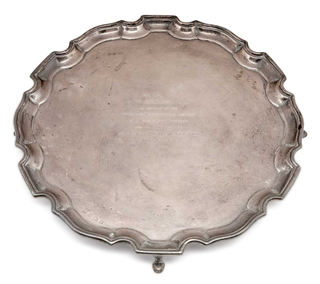 A GEORGE VI SILVER SALVER: by Ernest W. Haywood, Birmingham 1937, of shaped outline with stepped pie crust rim in the Chippendale style, raised on four pad feet, presentation engraved Presented to Mrs. G.E. Lowe J.P., on behalf
