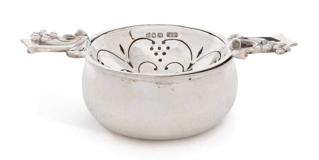 A SILVER TEA STRAINER ON STAND (1 of 3)