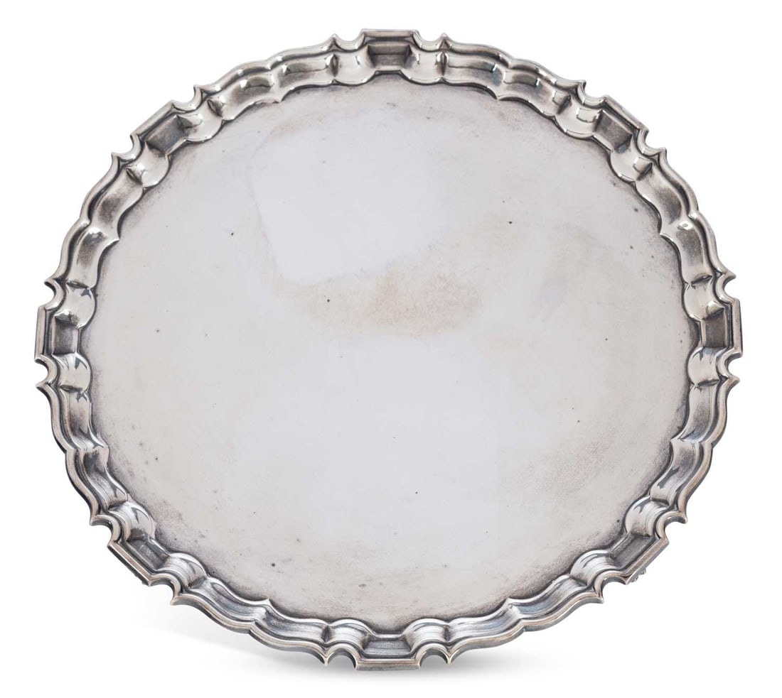 A GEORGE VI SILVER SALVER: by Barker Brothers Silver Ltd, Birmingham 1942, of circular form, with pie crust edge and four paw feet. 25.5cm diameter, 23 troy ounces