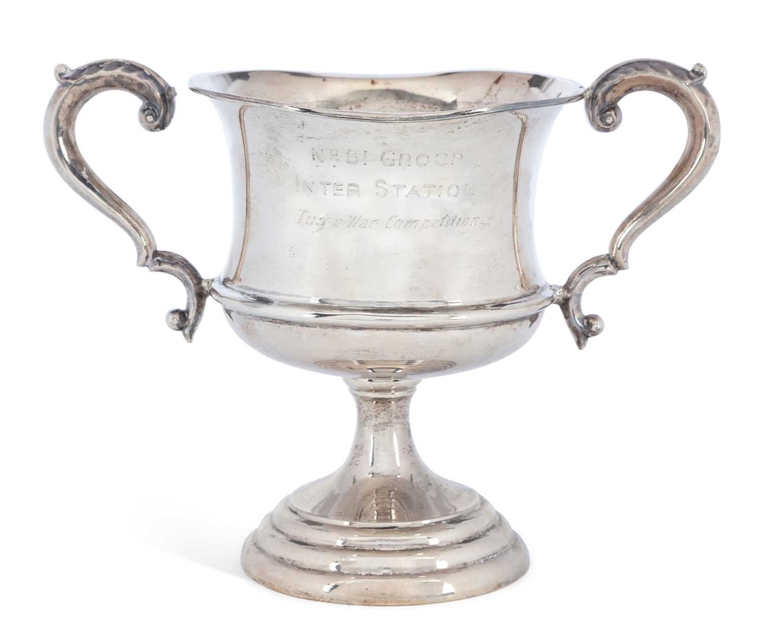 A GEORGE VI SILVER TROPHY CUP: by William Bruford & Son Ltd, Sheffield 1937, of inverted bell shape, the two S-scroll handles with acanthus leaf thumb pieces, to a waisted stem pedestal, raised on a stepped circular base, with pres