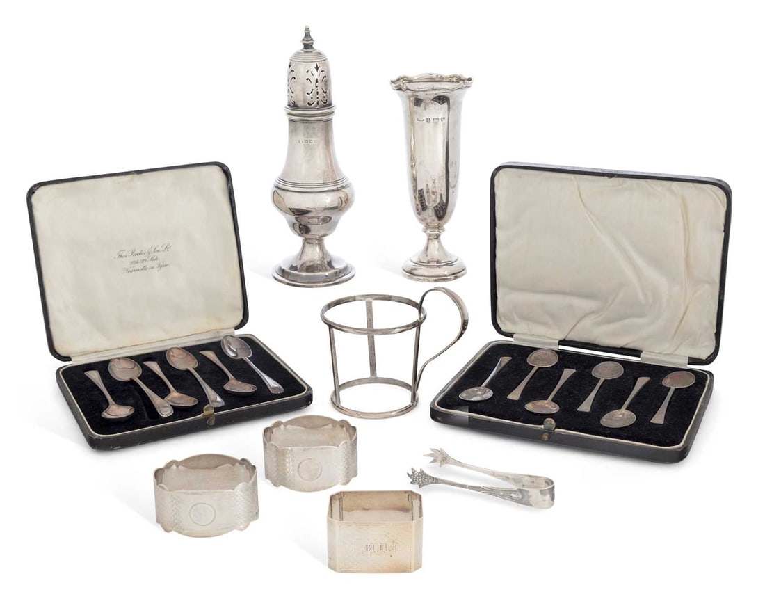 A GROUP OF ASSORTED SILVER: comprising a George V sugar sifter, of baluster form with reeded borders on a spreading circular foot; a pair of napkin rings with engine turned decoration; a further napkin ring by Walker & Hall; a p