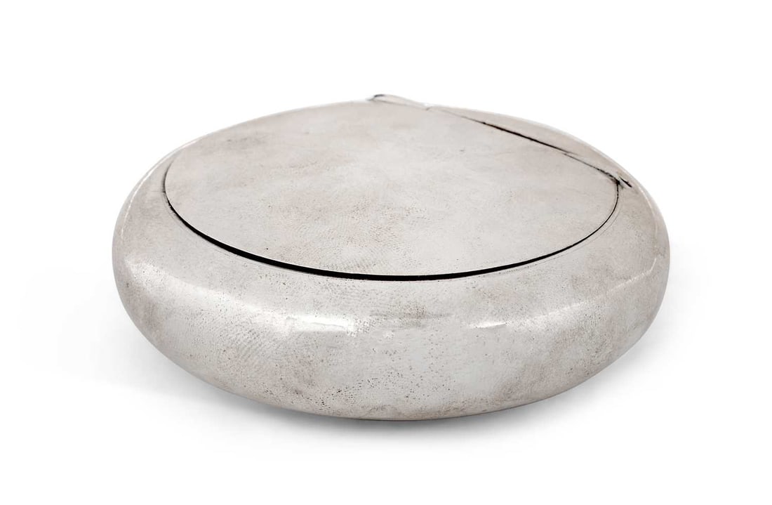 A GEORGE V SILVER SNUFF BOX: maker's mark unclear, Birmingham 1912, of plain compressed circular form, with hinged cover, gilt wash interior. 8cm diameter, 2.6 troy ounces Signs of wear, cover latch not catching, some tarnish.