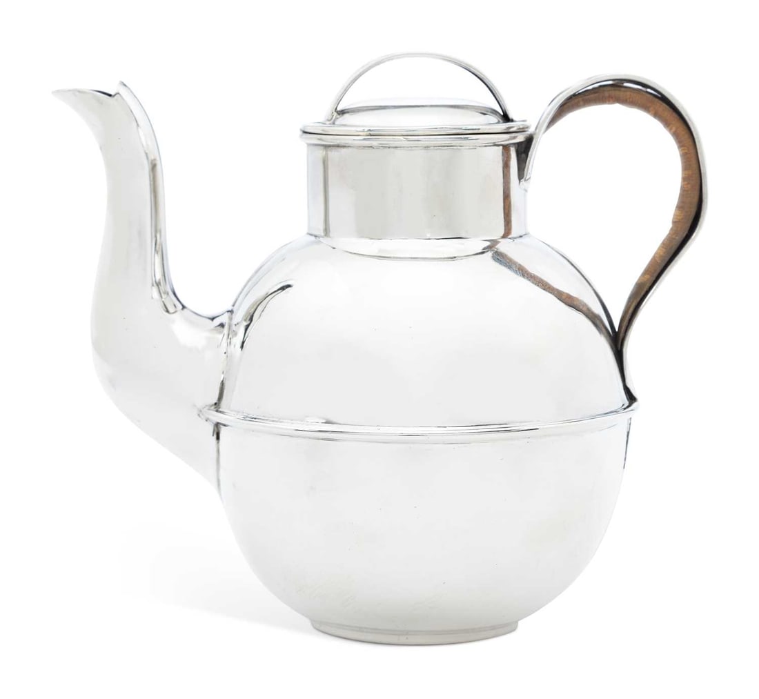 AN EDWARDIAN SILVER GUERNSEY CREAM JUG: maker's mark rubbed, Birmingham 1902, base stamped Bachmann & Co., Guernsey, of globular form with cane-lined handle. 12.5cm high, 8 troy ounces
