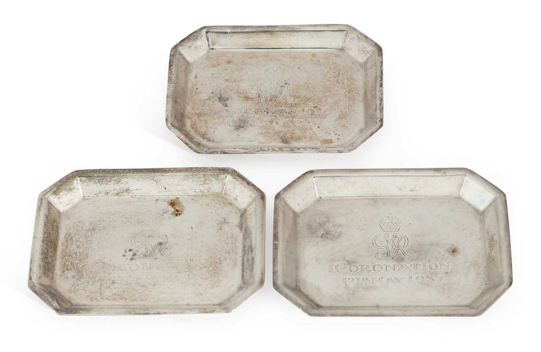 A SET OF THREE COMMEMORATIVE GEORGE V SILVER DISHES: by Adie Brothers, Birmingham 1935 (Jubilee hallmark), additionally stamped Asprey London, each of elongated octagonal form, engraved to centre GRVI CORONATION 12TH MAY 1937. (3) 8.4cm by 6.5cm, 3.7