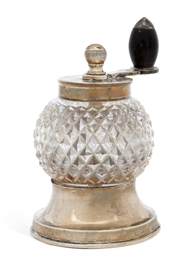 A LATE VICTORIAN SILVER-MOUNTED CUT GLASS PEPPER MILL: by John Grinsell & Sons, London 1896, of globular form with diamond-cut pattern and turned wooden handle, on a spreading circular foot, the mechanism marked Peugeot Freres Brevets S.G.D.G. 8.5cm high