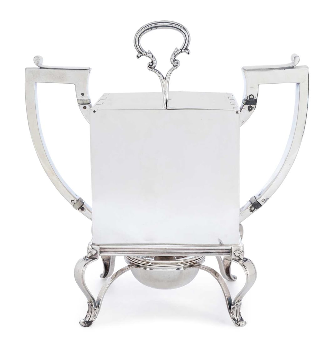 CITES - PAUL STORR: A RARE GEORGE IV SILVER EGG CODDLER: by Paul Storr, London 1824, of plain square form with twin angular handles, the double flat-hinged cover opening to reveal a coddler for four eggs, with double scroll handle, raised on four open leaf 