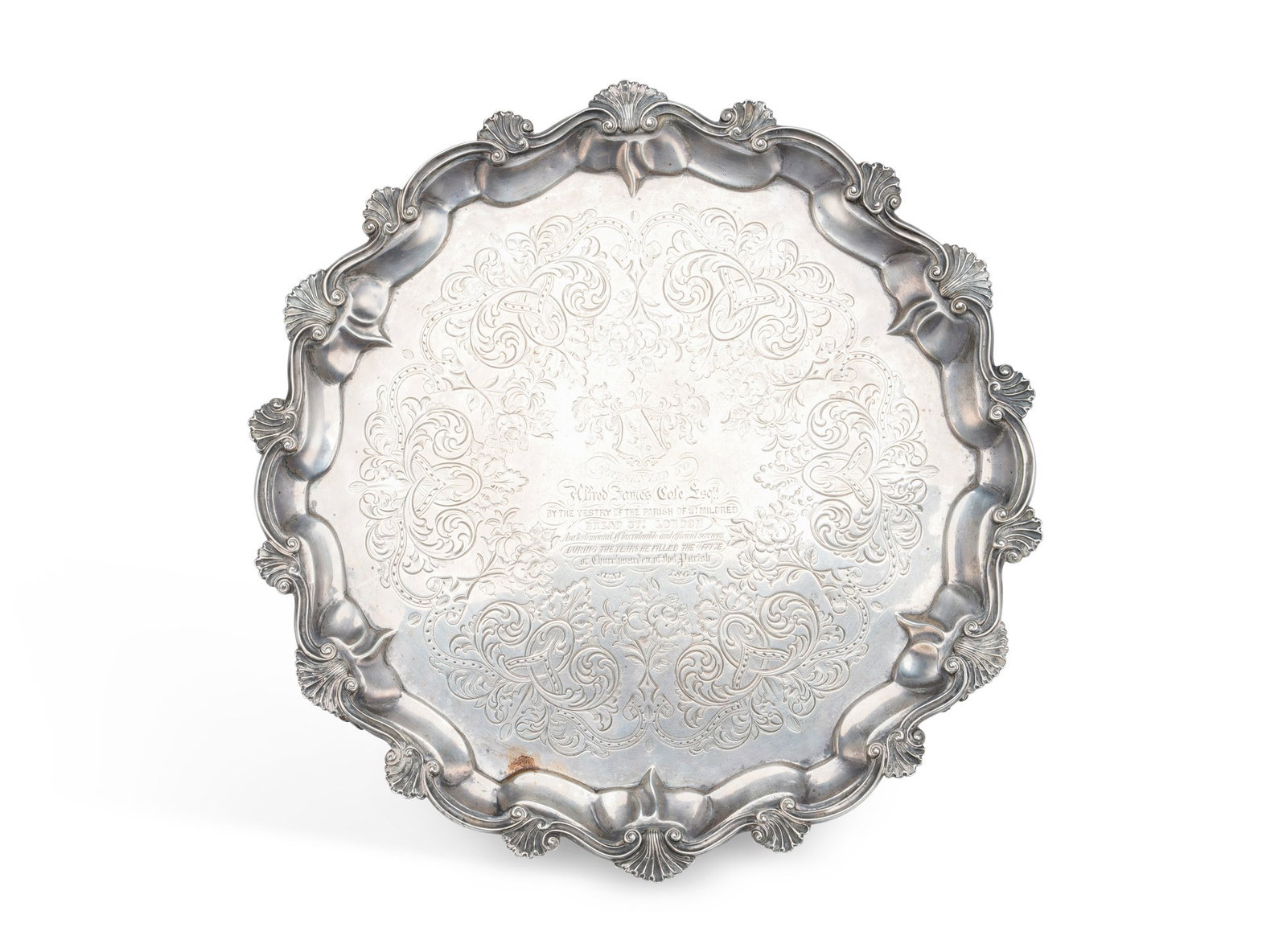 A LARGE VICTORIAN SILVER SALVER: by Daniel & Charles Houle, London 1862, of shaped circular form with a cast shell and scroll border, the centre engraved with an armorial above a presentation inscription reading Presented to Alfred
