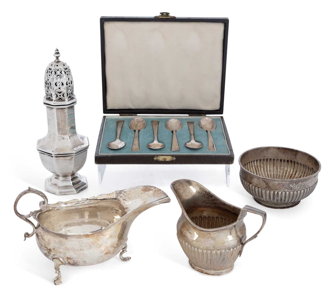 A GROUP OF VICTORIAN AND LATER SILVER: comprising a Victorian cream jug and sugar basin by Frederick Brasted, London 1876, each demi-fluted, the sugar bowl on circular foot; a George V caster, of octagonal baluster form, on a stepped