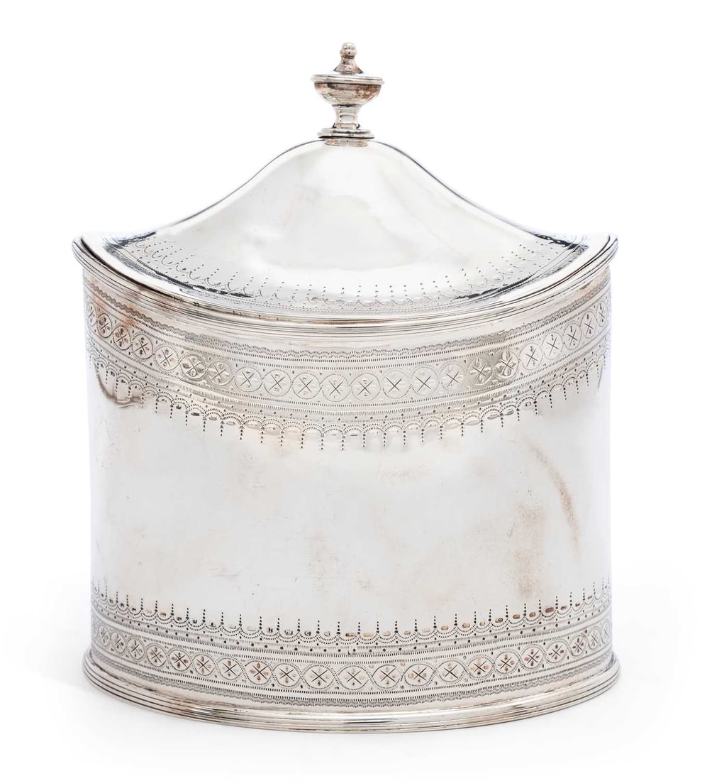 HESTER BATEMAN: A GEORGE IV / WILLIAM IV SILVER TEA CADDY: by Hester Bateman, London 1830, of oval form, the domed hinged cover with urn finial, engraved Neoclassical style decoration, with reeded borders. 16cm high, 12.2 troy ounces Good condition overall in