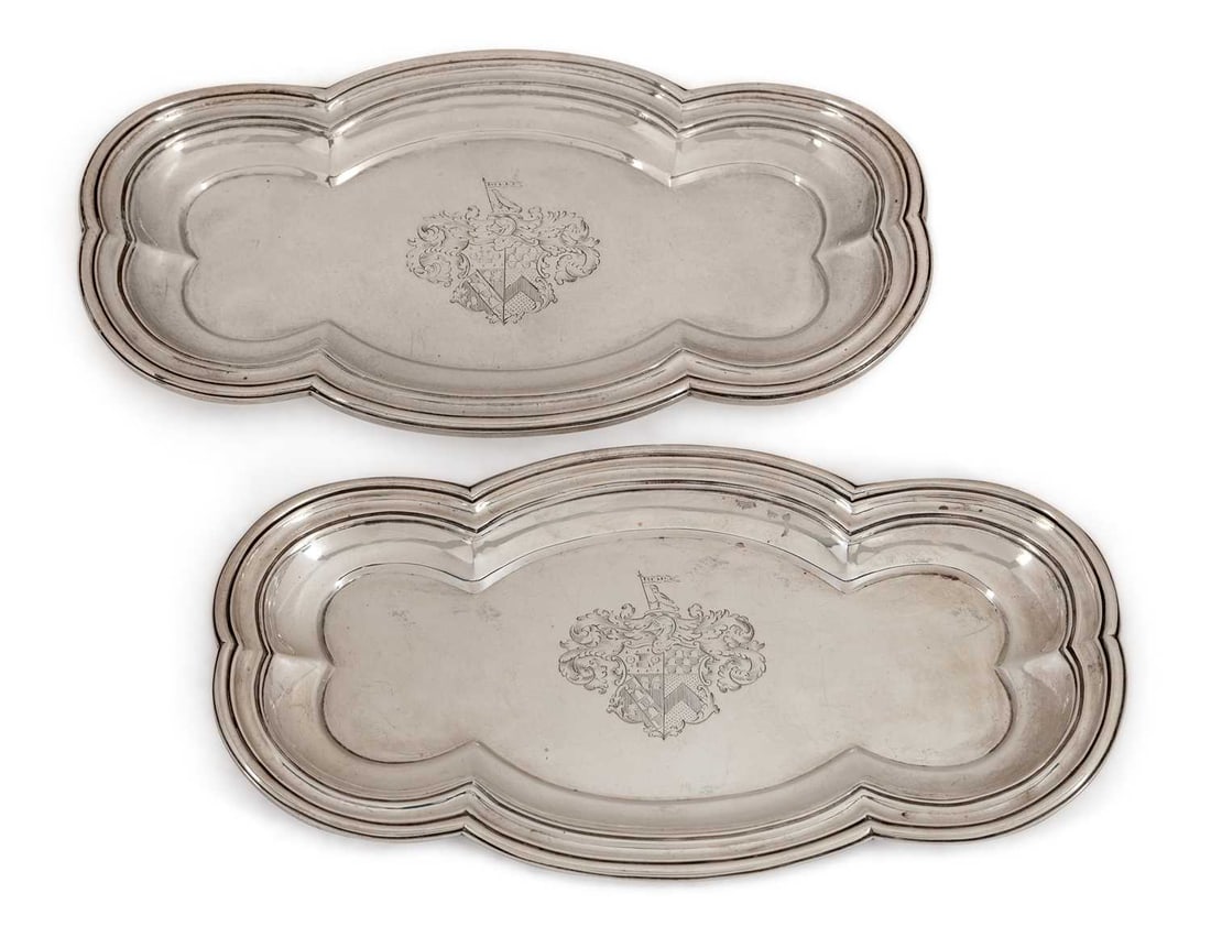 A PAIR OF GEORGE IV SILVER SNUFFER TRAYS: by Benjamin Smith, London 1824, of lobed rectangular form with moulded rim, each engraved with an armorial. (2) 23cm long, 12cm wide, 23.9 troy ounces gross