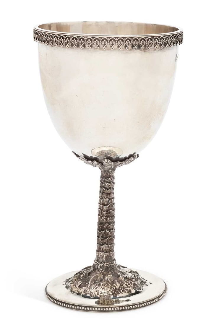 A VICTORIAN SILVER GOBLET: by Carrington & Co, London 1872, the rounded cup with beaded upper rim and textured stem, the circular foot decorated with relief depicting roots and leaves. 17cm, 5.2 troy ounces