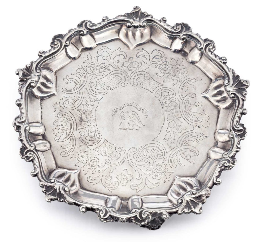 A GEORGE III SILVER WAITER: by John Schofield, London 1778, of shaped octagonal form, the rim cast with scroll and shell motif, foliate engraved to plate with central engraved eagle with outspread winged and motto Fortuna