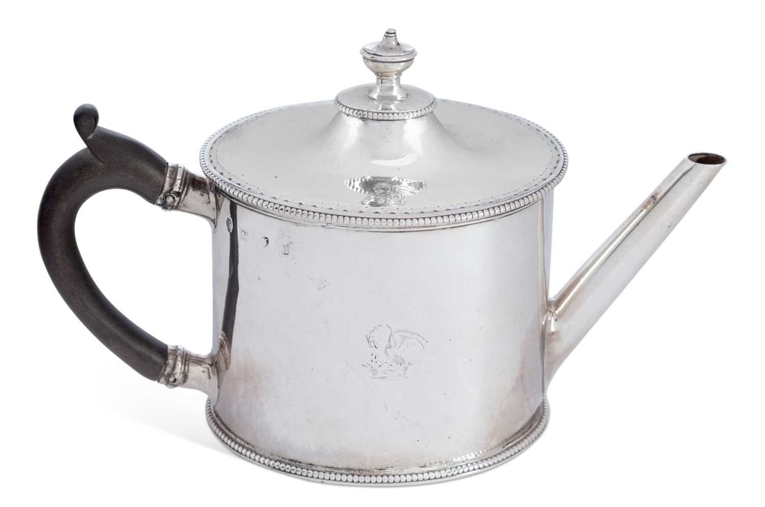 A GEORGE III SILVER ARGYLE: by Charles Aldridge & Henry Green, London 1779, of cylindrical form with a C-scroll handle and straight spout, bead-wire trimming along lower rim of lid and base, engraved crest on lid and main body.
