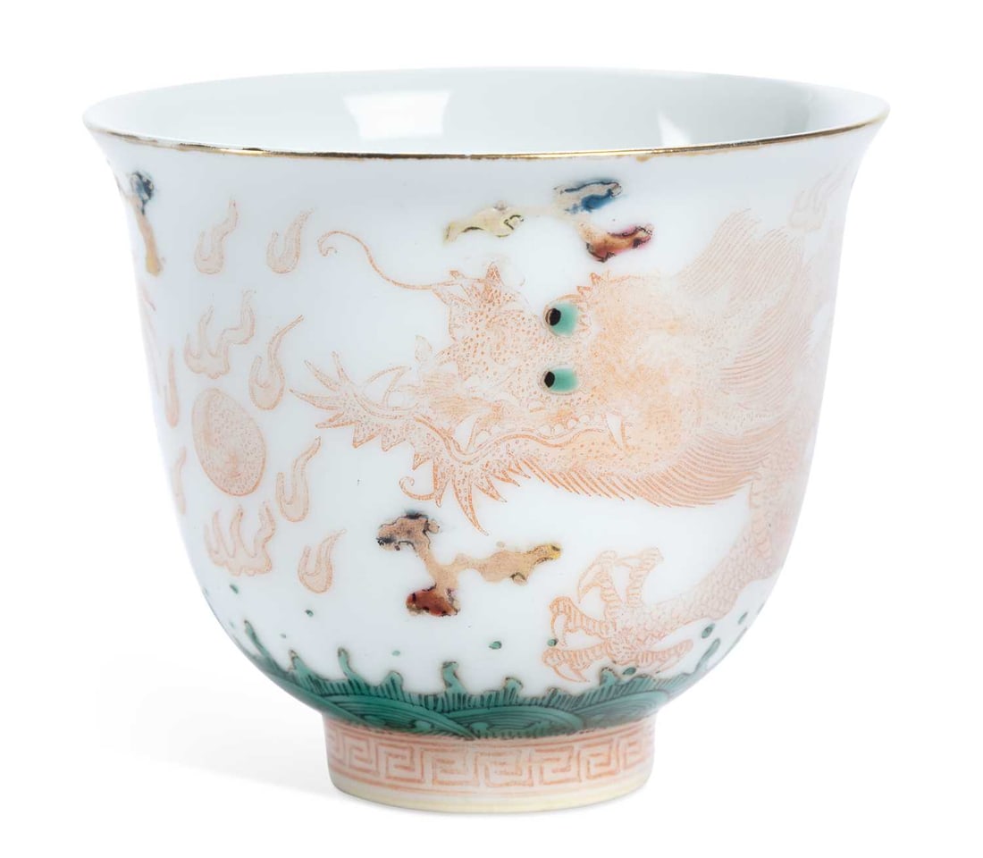 A CHINESE PORCELAIN BEAKER: painted in iron-red with a dragon chasing a flaming pearl, over waves, Yongzheng six character mark to the base. 7cm high