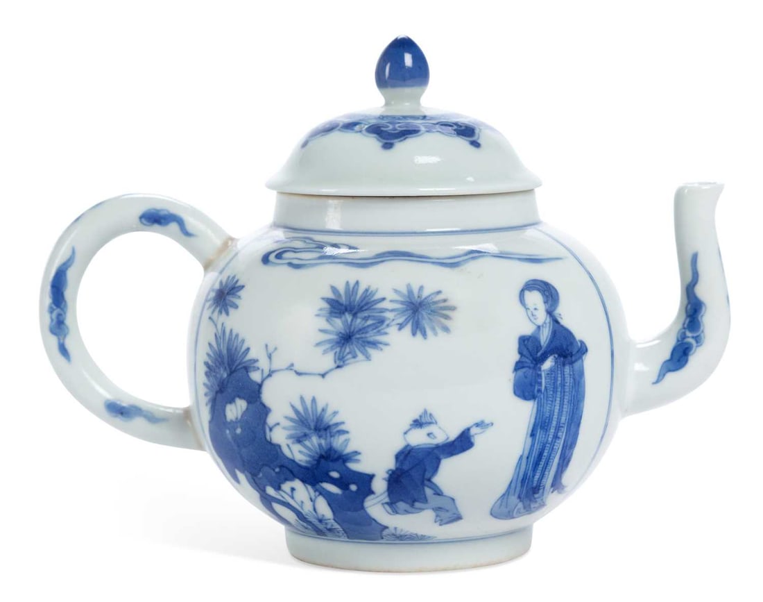 A CHINESE PORCELAIN BLUE AND WHITE TEAPOT: painted with figures in gardens, retrospective Jiajing six character mark to the base. 12.5cm high
