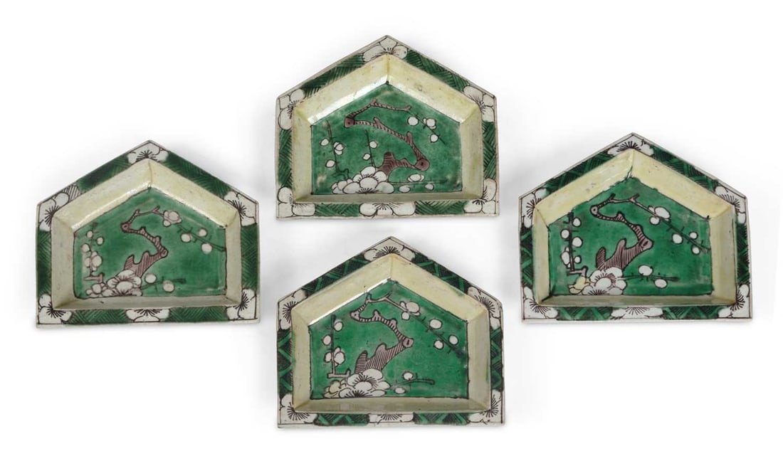 A SET OF FOUR CHINESE FAMILLE VERTE BISCUIT PORCELAIN TRAYS 18TH CENTURY: each shaped tray painted with flowering branches, within chevron borders, in famille verte enamels. 10.5cm wide