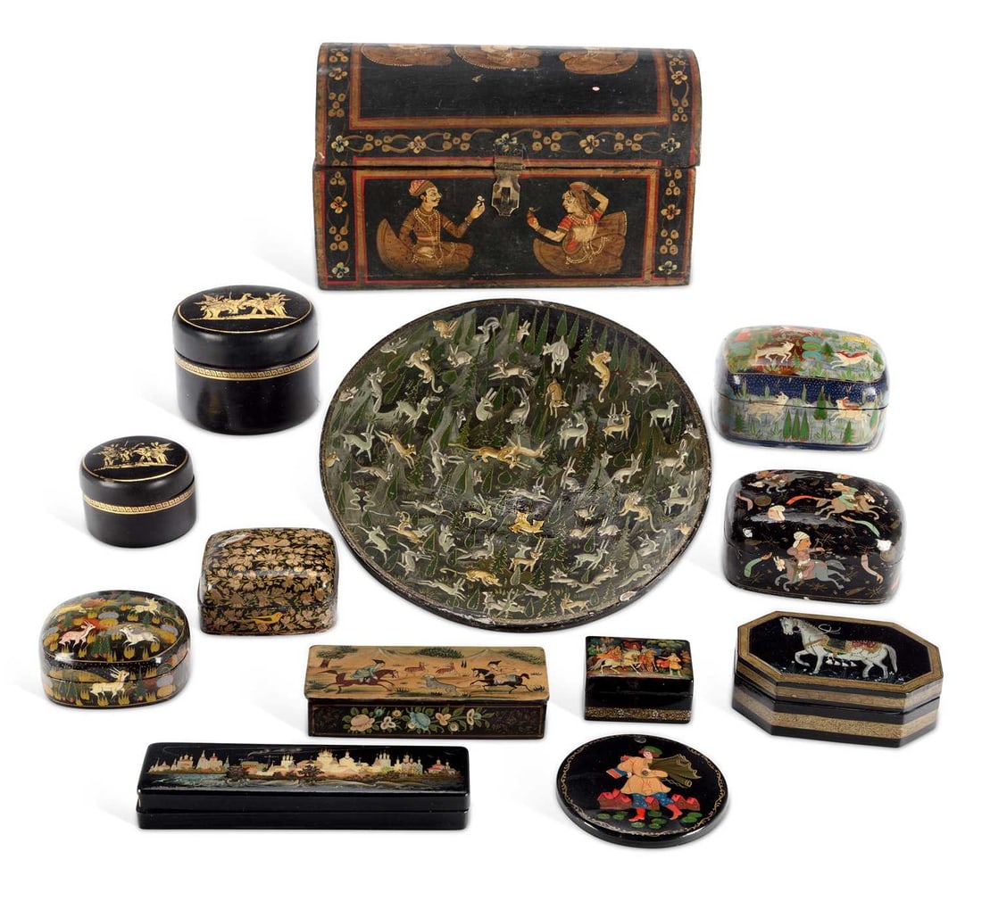 A COLLECTION OF INDIAN/ PERSIAN LACQUERED PAPIER-MACHE BOXES LATE 19TH/ 20TH CENTURY: comprising seven Indo-Persian, with hand painted decoration; a pair of round boxes decorated in gilt against black ground; one a Russian pen box; together with a dish decorated with animals labelled t