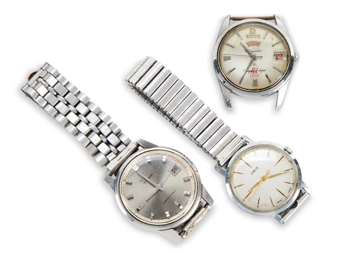 A GROUP OF MECHANICAL WATCHES: comprising a steel Titus Automatic Day Date Jetpower Super watch head; a steel Oris with a manually wound movement and expanding bracelet; and a Seiko Sportsmatic Diashock on steel bracelet. (3) Last 