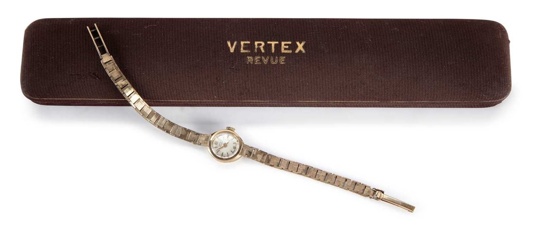 A LADY'S 9CT GOLD VERTEX BRACELET WATCH: the circular silvered dial signed Vertex Revue, with gilt baton indices with Arabic 6/12 markers, gilt hands, plain crown, integral bracelet with snap and ladder catch and safety catch, manually wound
