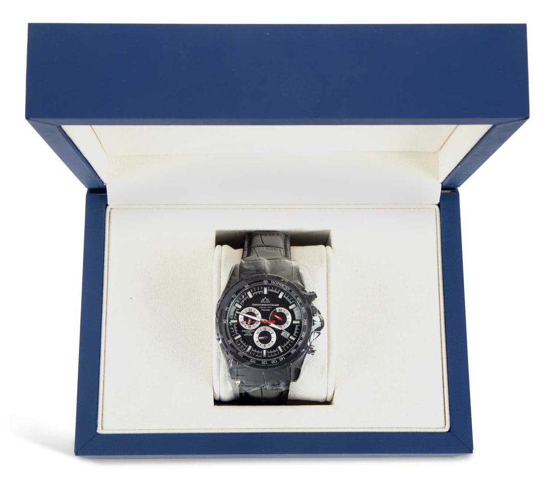 A GENTS STEEL CHRISTOPHE DUCHAMP QUARTZ CHRONOGRAPH STRAP WATCH: the circular black dial signed Christophe Duchamp Volcan, with luminous baton indices and sword hands, date aperture at the 3 o'clock position, silver sub-dials, black case, fitted with a black