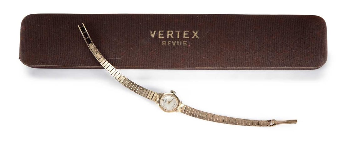 A LADY'S 9CT GOLD VERTEX REVUE BRACELET WATCH: the circular silvered dial signed Vertex Revue, with gilt baton indices and Arabic 6/12 numerals, original crown, integral bracelet with a snap and ladder catch and safety catch, push-on case back, mo