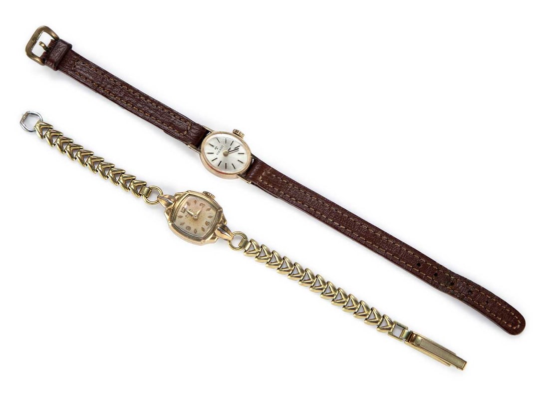 A LADY'S 9CT GOLD TISSOT STRAP WATCH AND AN AVIA WATCH: comprising the silvered oval dial signed Tissot, with black/ gilt baton indices and black hands, original crown, push-on case back, hallmarked 9ct gold; together with a Lady's gold plated Avia strap w